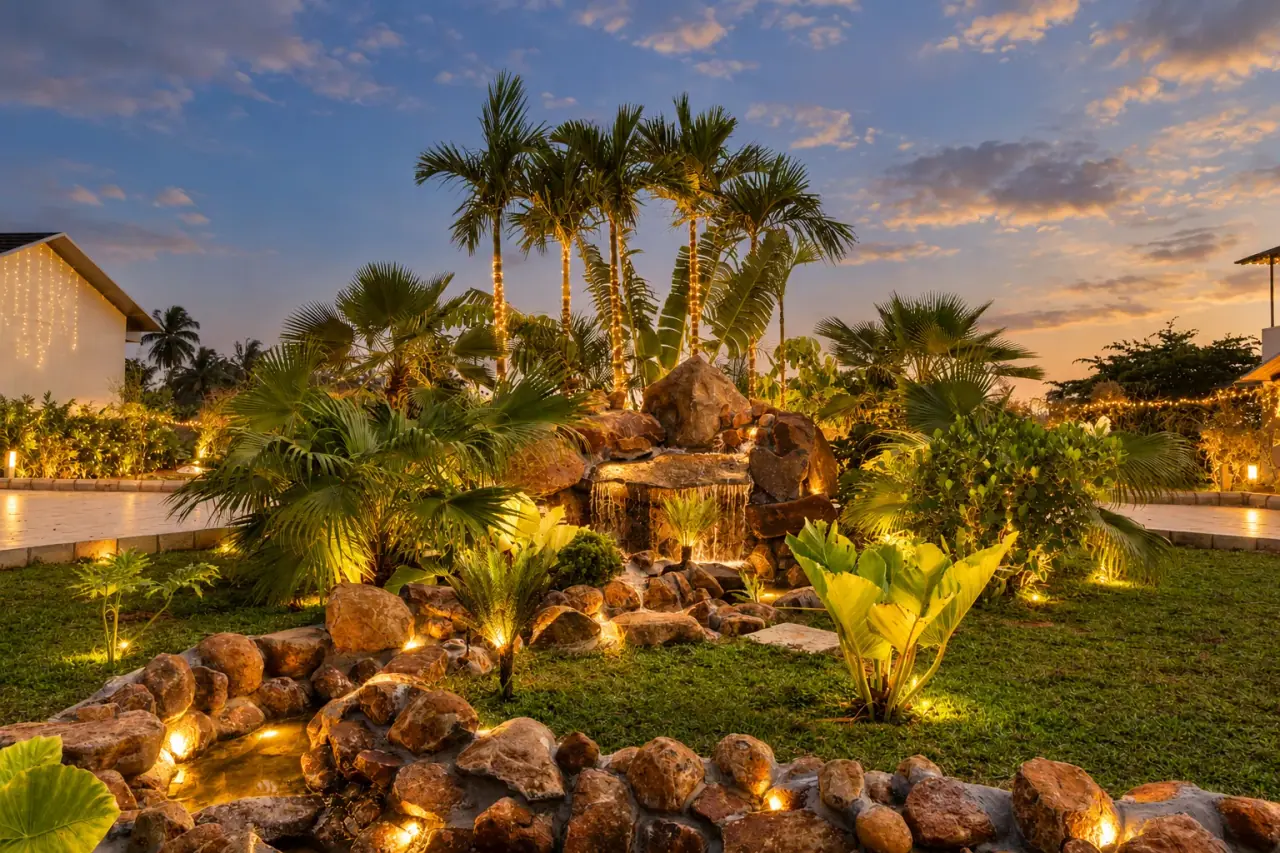 Illuminated garden and waterfall for an evening celebration