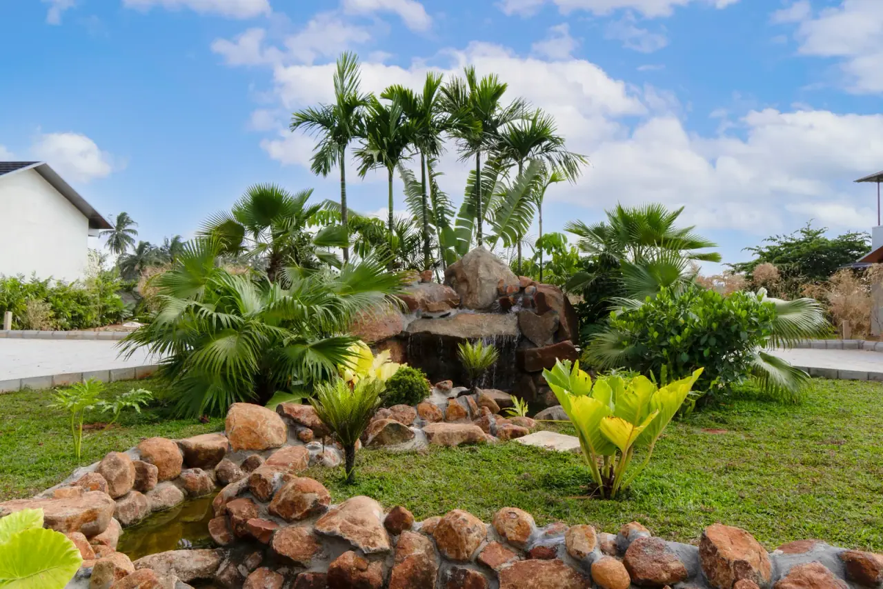Tropical gardens, palms and rock landscaping at Inari Meadows